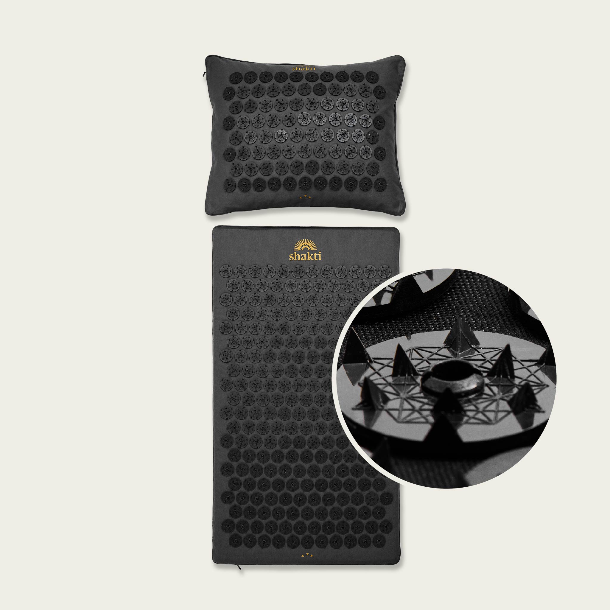 Black acupressure mat and pillow set with 'Shakti' branding on a beige background.